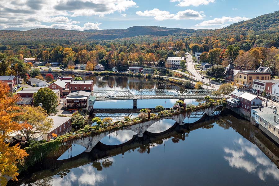 Shelburne Falls MA - Aerial View of the Bridge of Flowers Across the Water in Shelburne Falls Massachusetts in the Fall with Colorful Foliage