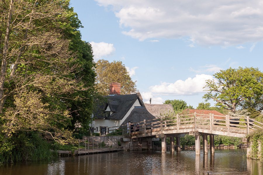 Dedham, MA - Bridge Over Water Near Home Surrounded by Trees